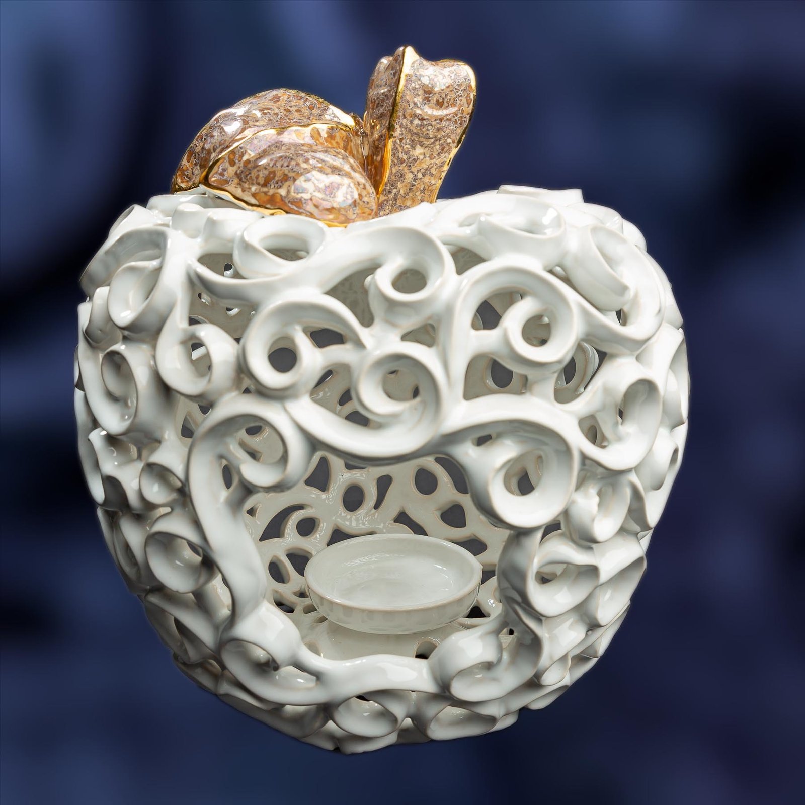 store_01GH3PA19DT5S64CY5FZFC6QWZ2Fassets2F1712760841047-MEI_042320copy.jpg Apple-Shaped Candle Holder - White color with a golden leaf and a stalk - Image 1